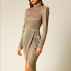 Stunning gold dress that glistens as you move. Features a wrap-inspired skirt.